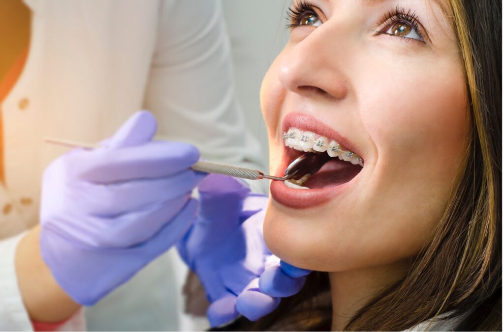 A person with braces being examined by an Orthodontist or Dentist
