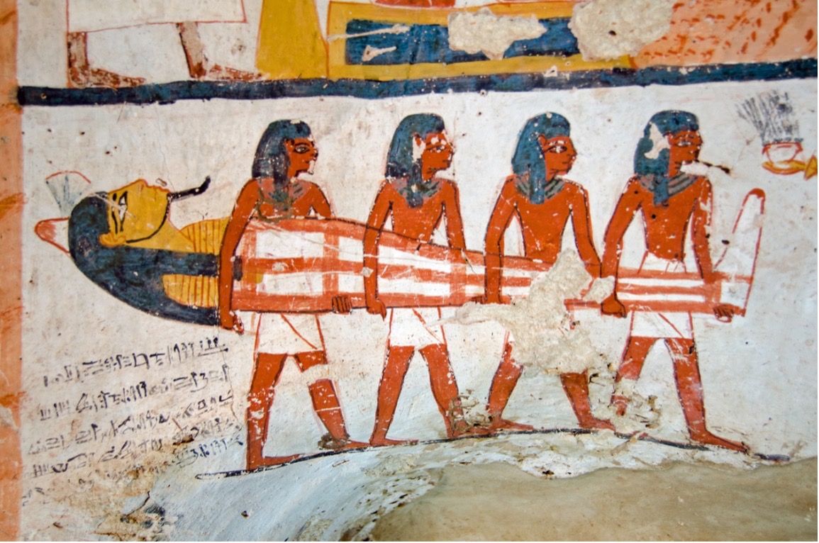 A group of ancient Egyptians carrying a sarcophagus