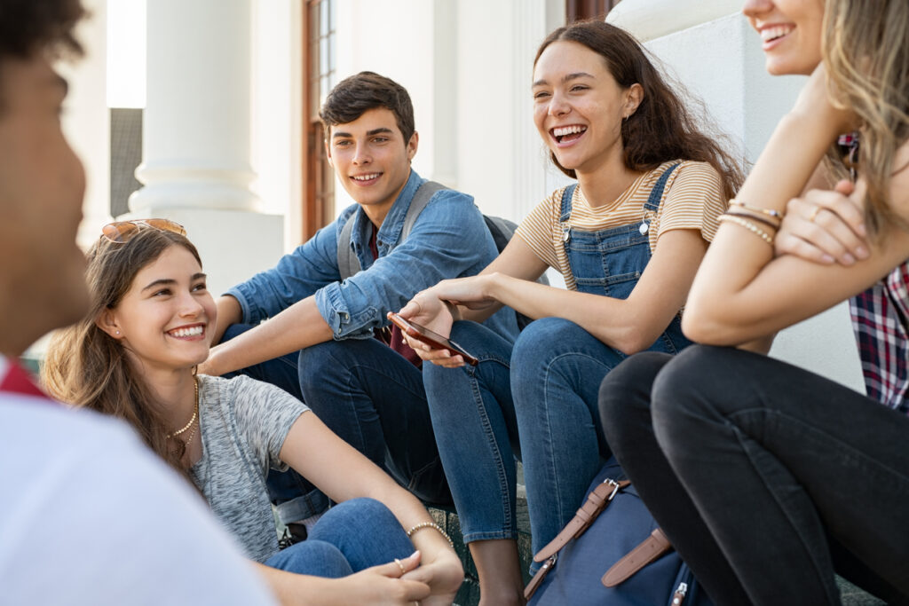 A group of people sitting on steps, Start the School Year Strong with Clear Aligners