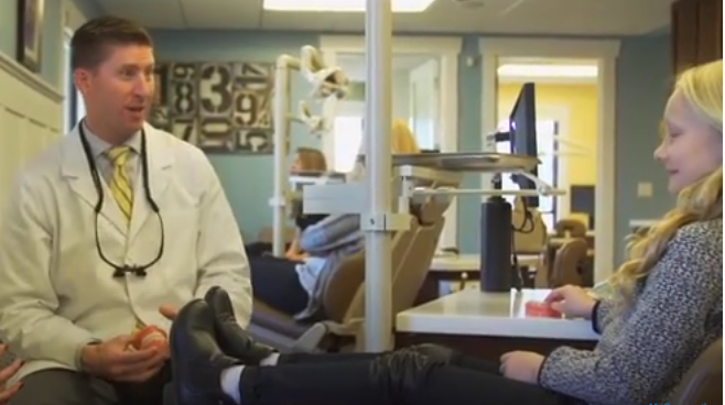 A doctor and patient in a dental office