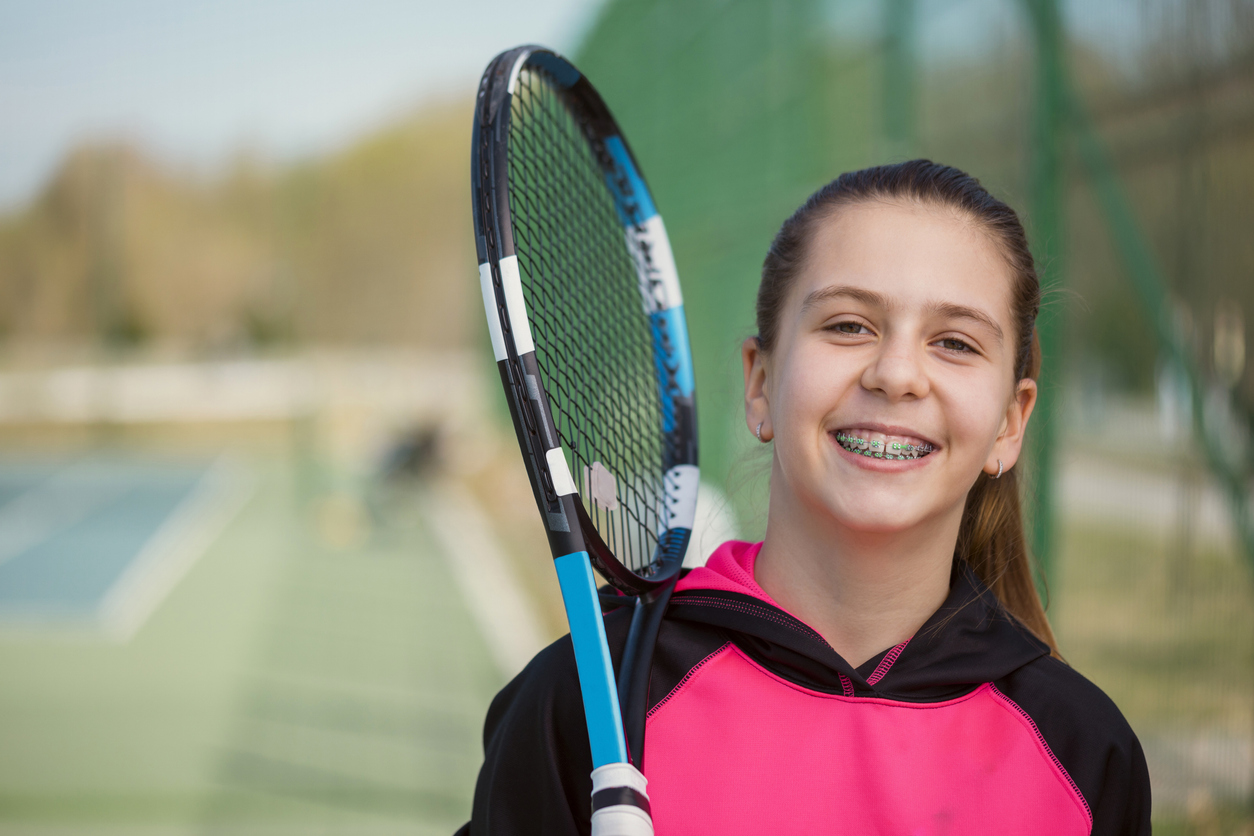 Playing Sports with Braces: How to Protect Your Smile , A child with a tennis racket